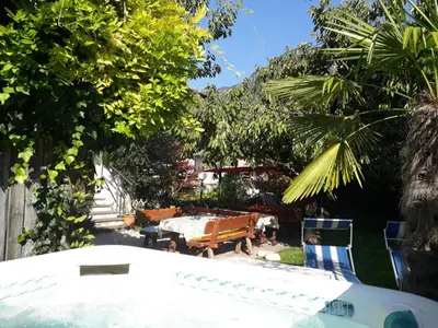 a backyard with a table and chairs and trees at Garni Meinrad in Ora/Auer