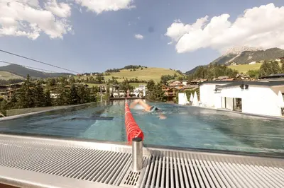 a swimming pool on the roof of a house at Al Plan, A mountain moving hotel in San Vigilio Di Marebbe