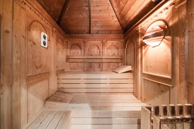 an empty sauna with wooden walls and wood floors at Al Plan, A mountain moving hotel in San Vigilio Di Marebbe