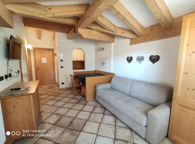 a living room with a couch and a table at Residence Montebel in Tesero