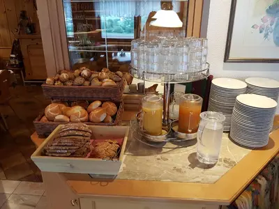 a table with a bunch of pastries and glasses of milk at Hotel Foestlerhof in Villa Ottone