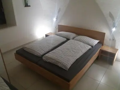 a bed with two pillows on it in a room at Haus Möltner - Apartment 