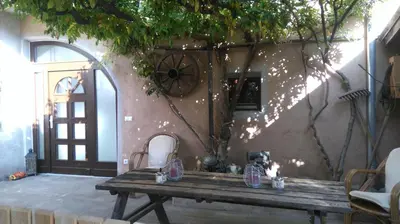 a wooden table sitting in front of a building at Haus Möltner - Apartment 