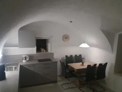 a kitchen and dining room with a table and chairs at Haus Möltner - Apartment 