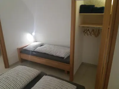 a small room with a bed and a closet at Haus Möltner - Apartment 