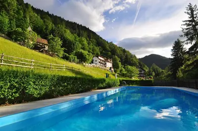 a swimming pool in the middle of a mountain at Bad St Isidor in Bolzano