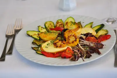 a plate of food with vegetables on a table at Bad St Isidor in Bolzano