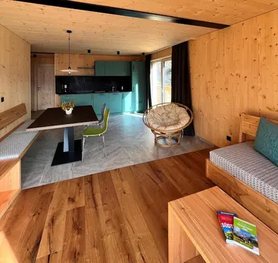 a living room with a table and a couch at Bio Felderhof in Villa Ottone