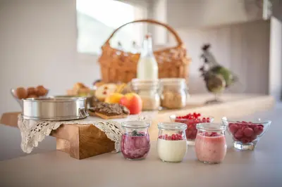 a kitchen counter with different types of food on a table at Ditterhof in Tesido