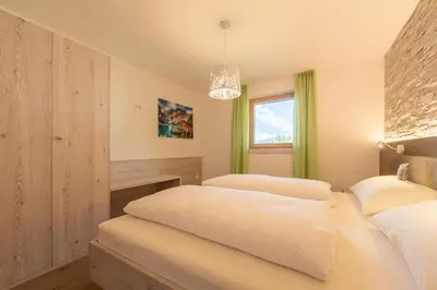 a bedroom with two beds and a window at Ditterhof in Tesido