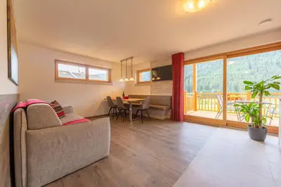 a living room with a couch and a table at Ditterhof in Tesido