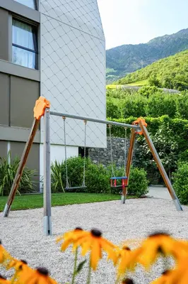a swing set in front of a building at Marchegg Apartments in Naturno