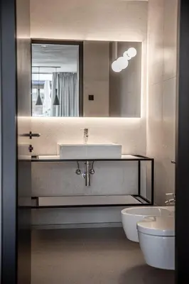 a bathroom with a sink and a toilet and a mirror at Marchegg Apartments in Naturno