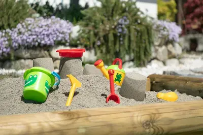 a toy sandbox with toys in the sand at Appartement-Hotel Beatenhof in Tirolo