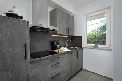 a kitchen with a sink and a window at Appartement-Hotel Beatenhof in Tirolo
