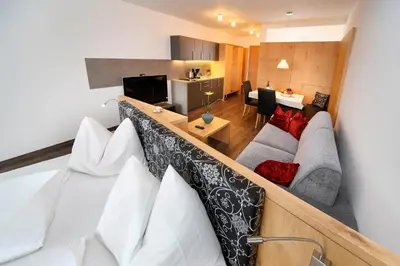 a view of a living room and kitchen from a loft at Appartement-Hotel Beatenhof in Tirolo