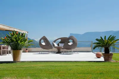 a group of chairs sitting on top of a patio at Appartement-Hotel Beatenhof in Tirolo