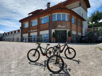 two bikes parked in front of a building at Hotel Amaten in Brunico
