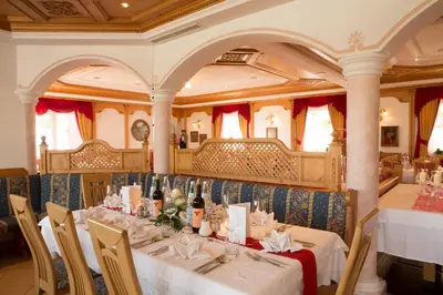 a dining room with a table in a train at Hotel Amaten in Brunico