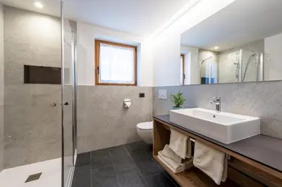 a bathroom with a sink and a shower at Ciasa Mascotte in San Vigilio Di Marebbe