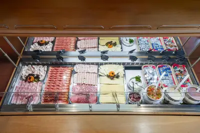 a refrigerator filled with lots of different types of food at Hotel St. Justina Hof in Appiano sulla Strada del Vino