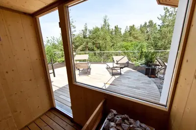 a view from the balcony of a cabin with a large window at Bio & BikeHotel Steineggerhof in Collepietra