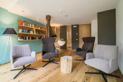 a living room with three chairs and a table at Bio & BikeHotel Steineggerhof in Collepietra