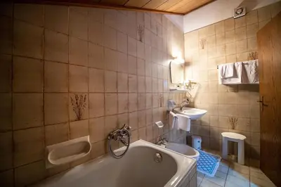 a bathroom with a tub and a sink at Apartments Zilli in Laion