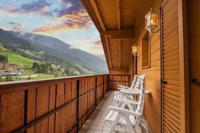 a balcony with two white chairs and a view at Apartments Zilli in Laion