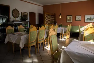 a dining room with tables and chairs in a restaurant at Hotel Gasthof WASTL in Appiano sulla Strada del Vino