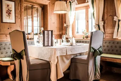 a dining room with a table and two chairs at Hotel Fürstenhof in Schenna