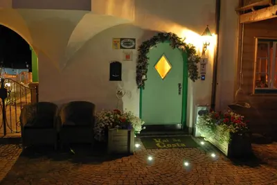 a green door on the side of a building at Garnì Val de Costa in Canazei