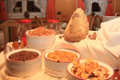 a table with bowls of food on a table at Garnì Val de Costa in Canazei
