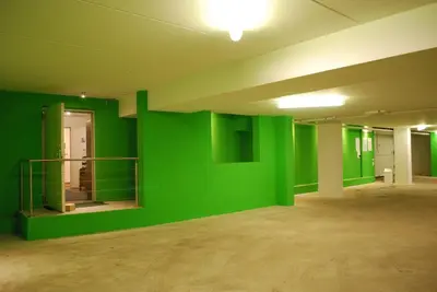 an empty room with green walls in an empty building at Garnì Val de Costa in Canazei