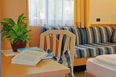 a room with a table with a book and a chair at Villa Sole in San Vigilio Di Marebbe