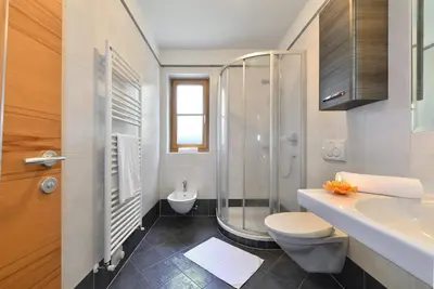 a bathroom with a shower and a toilet and a sink at Villa Sole in San Vigilio Di Marebbe