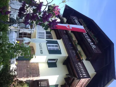a building with flowers on the side of it at Hotel Latemar in Soprabolzano