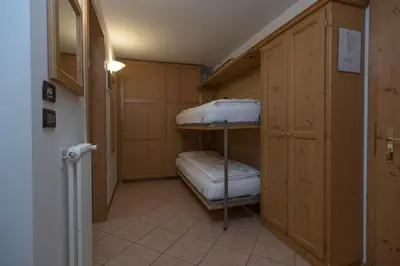 a room with two bunk beds in a room at Residence Kristall- Fiemme Holidays in Predazzo