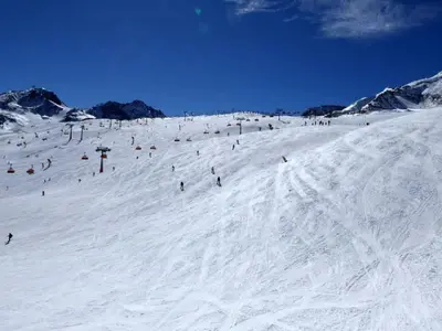 a group of people skiing down a snow covered slope at Casa a piè di pista in Tesero