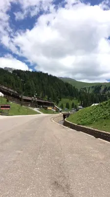 an empty road with mountains in the background at Casa a piè di pista in Tesero