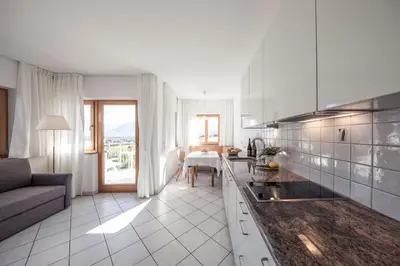 a kitchen and living room with a couch and a table at Weingut Donà in Appiano sulla Strada del Vino