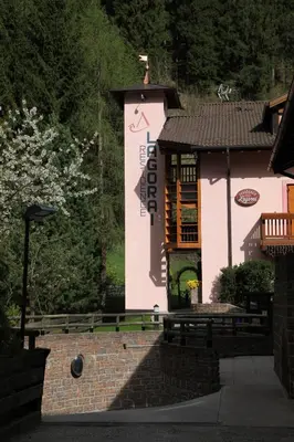 a building with a sign on the side of it at Residence Lagorai - Fiemme Holidays in Predazzo