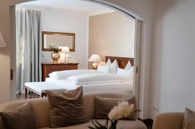 a hotel room with two beds and a mirror at Hotel Hanswirt in Rablà