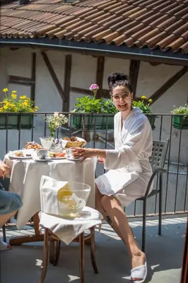 a man sitting at a table with a plate of food at rössl bianco b&b&b in Merano