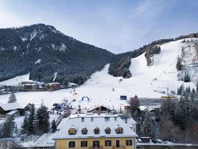 a ski resort with a snow covered mountain in the background at Ciasa Cianins in San Vigilio Di Marebbe