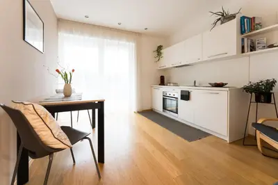 a kitchen with a table and a dining room at Apartment Oberlechner in Riscone