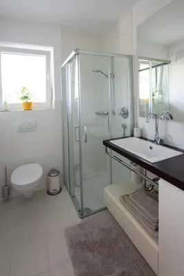a bathroom with a shower and a sink and a toilet at Apartment Oberlechner in Riscone