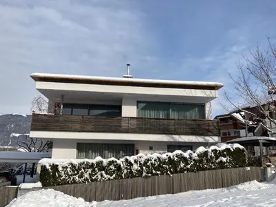 a house with a fence in the snow at Apartment Oberlechner in Riscone