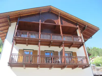 a house with a balcony on top of it at Villa Ula Verda- Apartments Marianna in Santa Cristina in Val Gardena