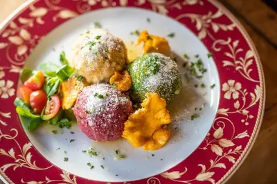a plate of food on a red and white plate at Solaia Hotel & Guesthouse in Castelrotto